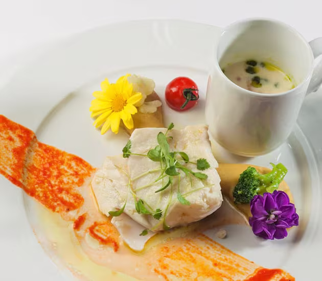 Confit fillet of Norwegian SKREI® with and mashed garbanzo beans and seasonal vegetables